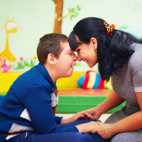 Soulful moment. Portrait of mother and her beloved son with disability in rehabilitation center